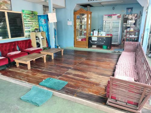 a store with wooden floors and benches in a room at Canaan in Kanchanaburi