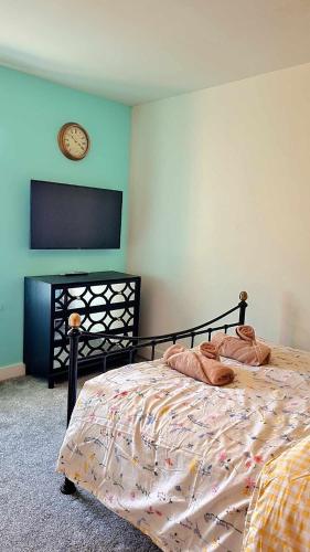 a bedroom with a bed with a clock on the wall at The Rest in Tarbert