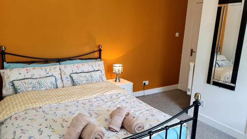a bedroom with a bed and a mirror on the wall at The Rest in Tarbert