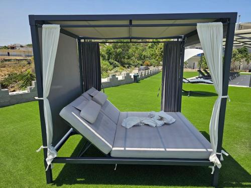 a swinging bed in a gazebo on a lawn at Nina Apartment in Chania Town