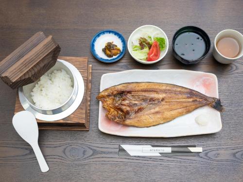 a table topped with a plate of food with rice at Nasu Kogen North Inn in Higashikoya