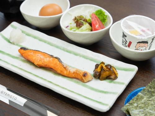 a plate of food with a carrot and a salad at Nasu Kogen North Inn in Higashikoya