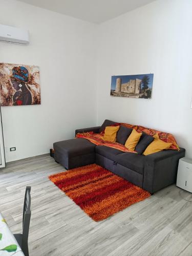 a couch in a living room with a rug at Il tramonto in Balestrate
