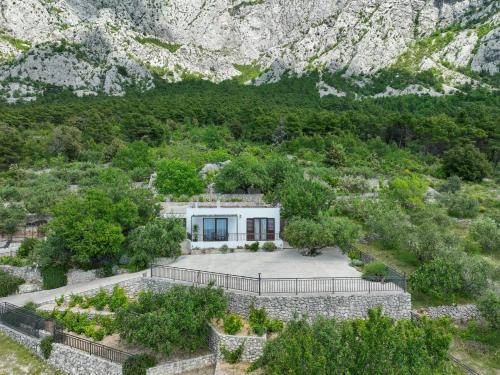 a house in the middle of a mountain at Holiday home Tranquillo in Makarska
