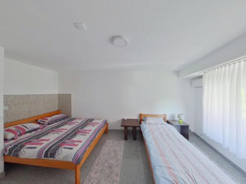 Кровать или кровати в номере Apartman Numero Uno 1