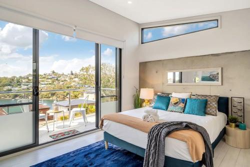 a bedroom with a large bed and a balcony at Picture-Perfect Masterpiece In Exclusive Mosman in Sydney