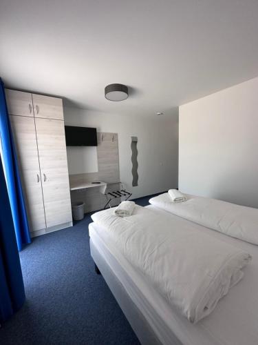 a hotel room with two beds and a tv at Marina Park Eberswalde in Eberswalde
