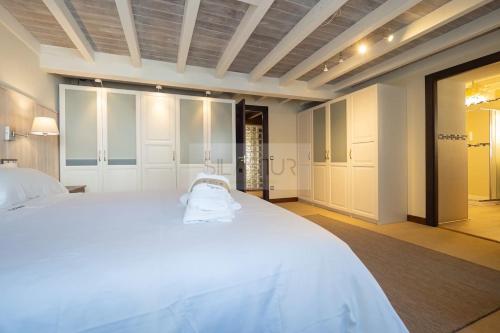 a bedroom with a large white bed in a room at El Gorin Casona in Gijón