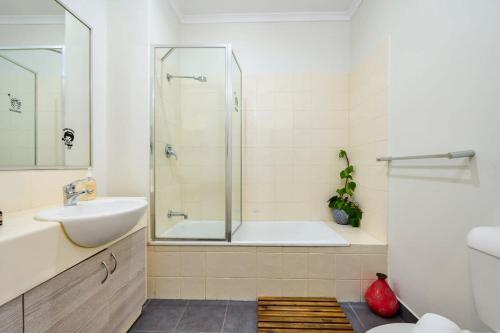 y baño con bañera, lavamanos y ducha. en Bright & Eclectic Home - Footscray VIC, en Melbourne