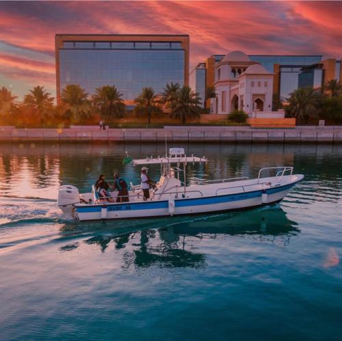 a group of people on a boat in the water at مارينا KAEC in King Abdullah Economic City
