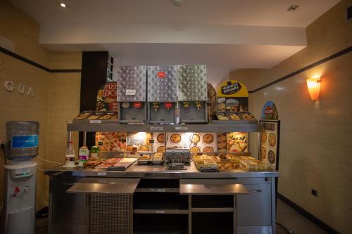 a bakery with a counter with donuts on it at Hotel LB Villa De Cuenca in Cuenca