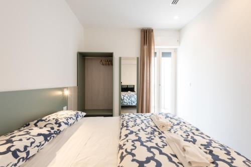 Кровать или кровати в номере La Perla del Mare Rooms