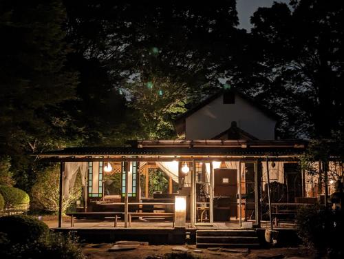 a large white house with lights on it at night at 貸切古民家別邸 in Tsukuba