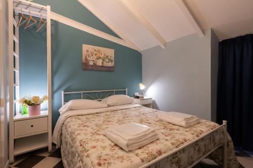 a bedroom with a bed with towels on it at HOSTEL PORTICI in Portici