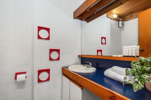 a bathroom with a sink and a mirror at 17 Cottesloe - Steps From Beach - Sleeps 2- SUPERHOG REQUIRED in Perth