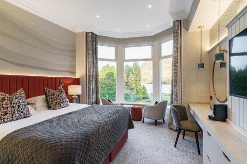 a bedroom with a bed and a large window at The Inn On The Lake in Glenridding