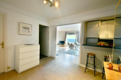 une cuisine avec des armoires blanches et une vue sur l'océan dans l'établissement Plage du midi- Vue sur mer Standing Presta, à Cannes