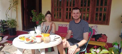 a man and a woman sitting at a table at Vegetable Garden House in Adams Peak