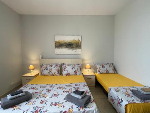 two beds in a small room with two lamps at Peak Apartment Sea View in Vollga Durres #3 in Durrës