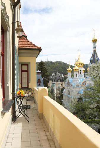 a balcony with a view of a city at Spa Hotel Villa Ritter in Karlovy Vary