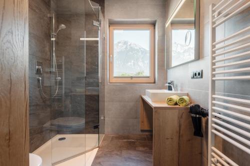 a bathroom with a shower and a sink and a toilet at Gasthof Pension Knapp in Strass im Zillertal
