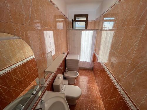 a bathroom with two toilets and two sinks at Peak Apartment Sea View in Vollga Durres #3 in Durrës