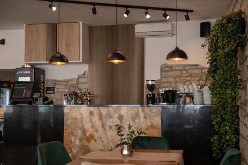 a restaurant with a bar with a table and chairs at Hotel Marina in Fažana