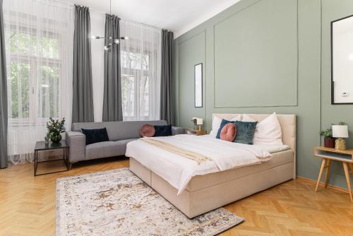 a bedroom with a bed and a couch at Fancy Home Prague #2 in Prague