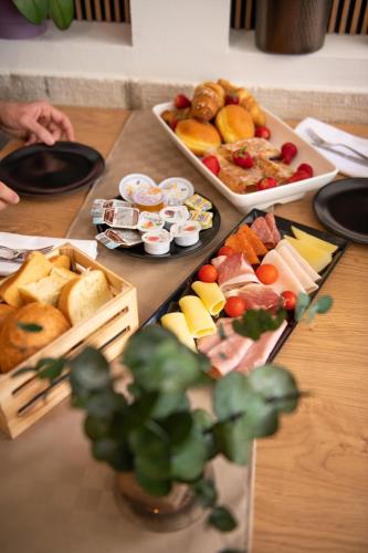 a table topped with lots of different types of food at Hotel Marina in Fažana