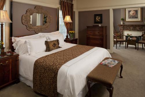 a bedroom with a large bed with a mirror at Fairview Inn in Jackson
