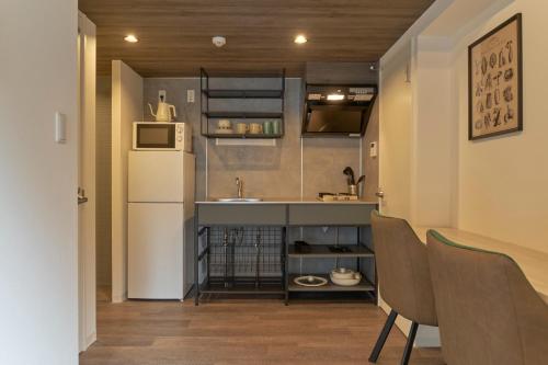 a small kitchen with a sink and a refrigerator at MATSUMIZAKA Hill by Tranova in Tokyo