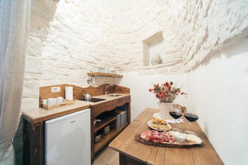 a kitchen with a table with a plate of food on it at Soave Relax & Wellness in Alberobello