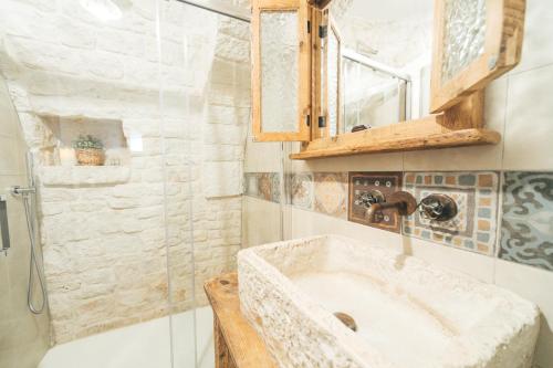 a bathroom with a sink and a shower at Soave Relax & Wellness in Alberobello