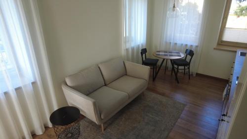a living room with a couch and a table at Žalio kalno apartamentai in Kaunas