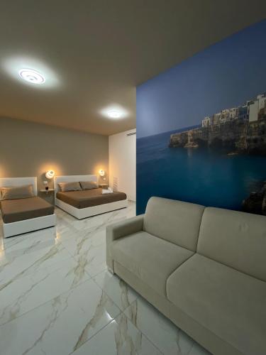 a living room with two beds and a couch at Angela's dreams in Conversano