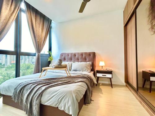 a bedroom with a large bed with a large window at Cozy Place 1-8 Pax 3 bedroom Ara Damansara in Petaling Jaya