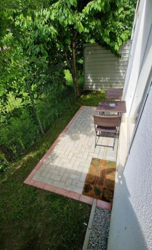 a patio with a table and two benches on it at Ap CALAS No2 2B, Free Parking in Râşnov