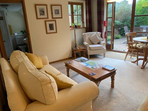 a living room with a couch and a coffee table at The Cottage Studio in Wool