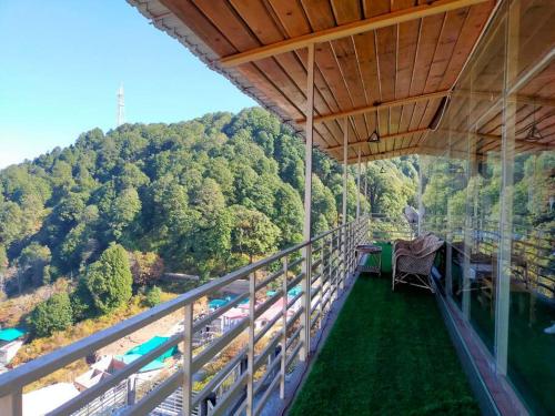 a balcony with a view of a mountain at Smooky Villa in Mukteswar