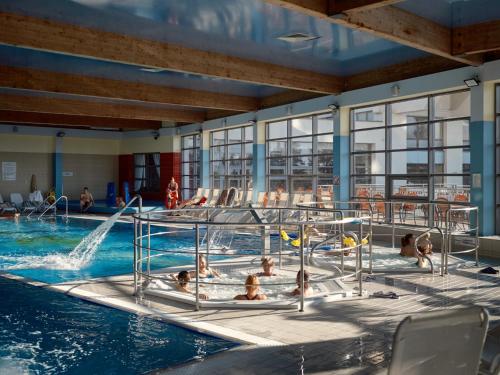 a group of people in a swimming pool at Miejsca noclegowe w Arka Medical SPA in Kołobrzeg