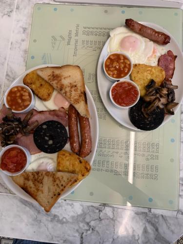 a plate of food with a sandwich and other foods at Hornby Villa- 4Star B&B-Couples & Families Only in Blackpool