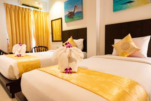 Ένα ή περισσότερα κρεβάτια σε δωμάτιο στο Q Victory Patong Hotel