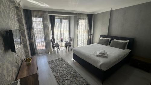 En eller flere senger på et rom på Taksim Royal Residence & Hotel