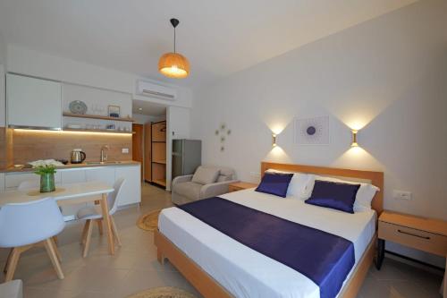 a bedroom with a large bed and a kitchen at Villa Pargua in Borsh