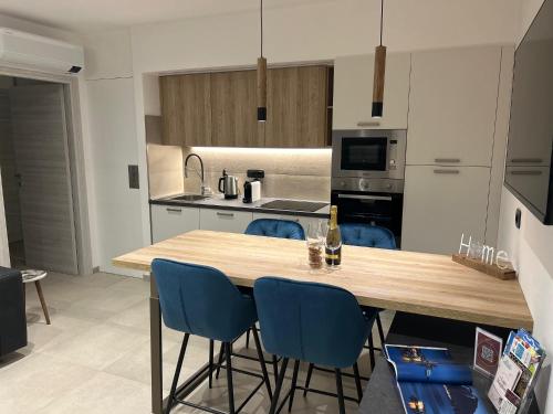 a kitchen with a wooden table and blue chairs at Lakes and Mountains Magic Holiday House in Omegna