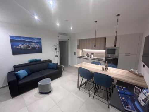 a kitchen and living room with a couch and a table at Lakes and Mountains Magic Holiday House in Omegna