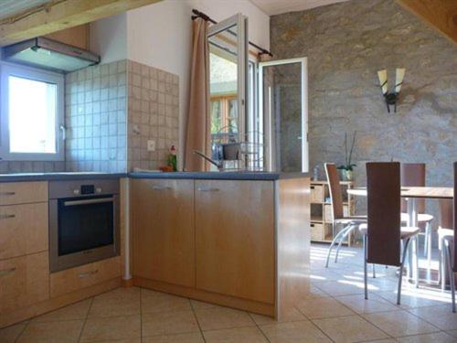 a large kitchen with a table and a dining room at Studio de Vacances Philipona in Granges