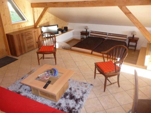 a living room with two chairs and a table at Studio de Vacances Philipona in Granges