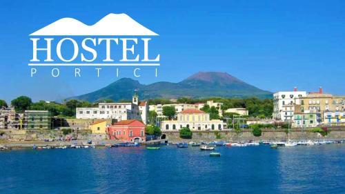 a view of a town with boats in the water at HOSTEL PORTICI in Portici