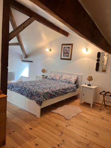 - une chambre avec un lit et 2 tables avec des lampes dans l'établissement Le Plantier 1, à Beaulieu-sur-Sonnette